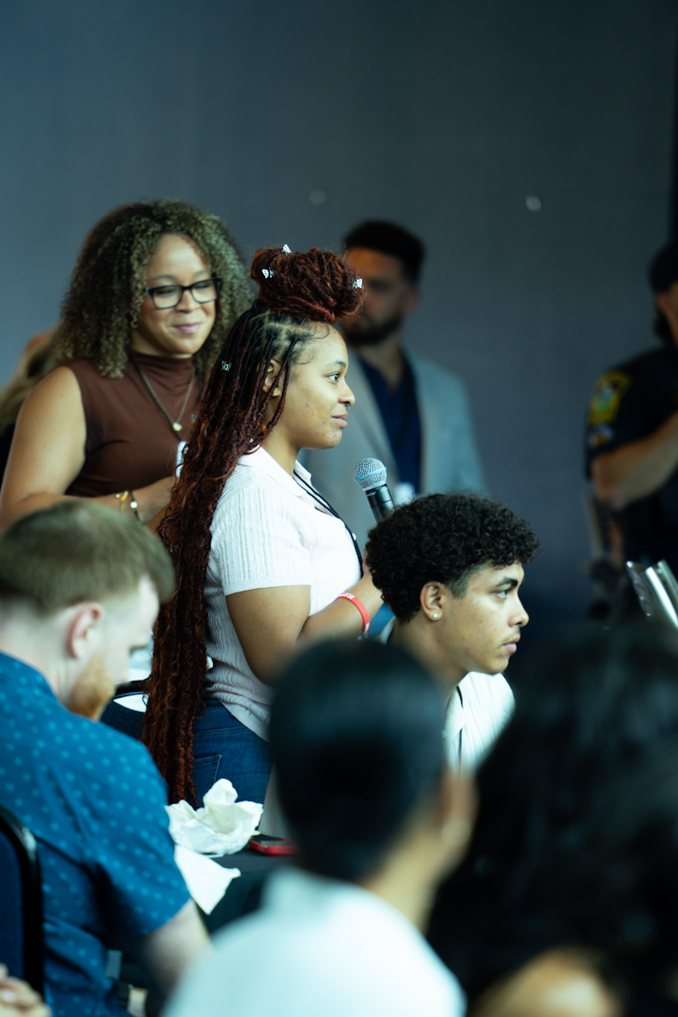 A young scholar asking a question from the audience