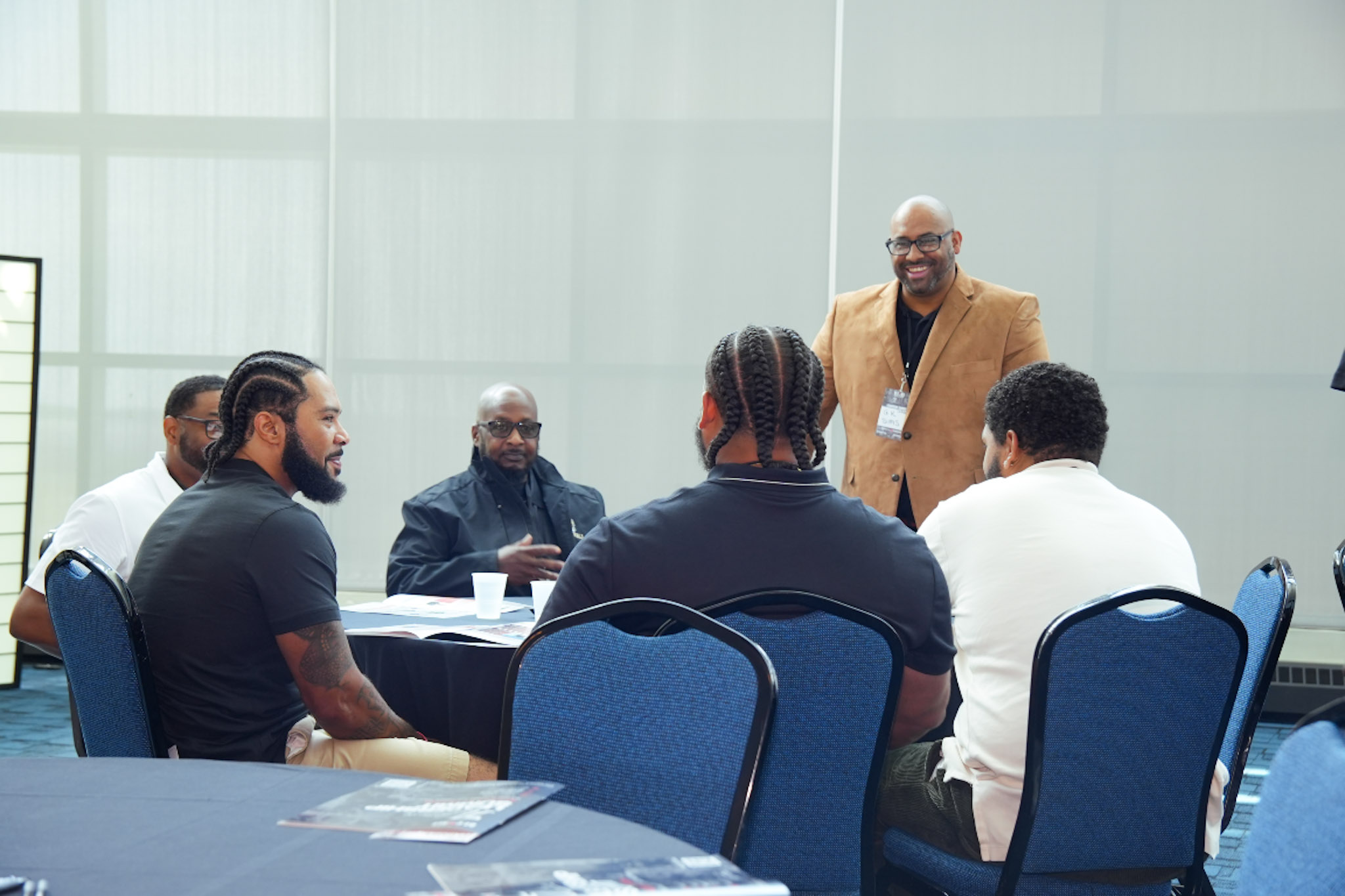 Mentors networking around a table during a breakout