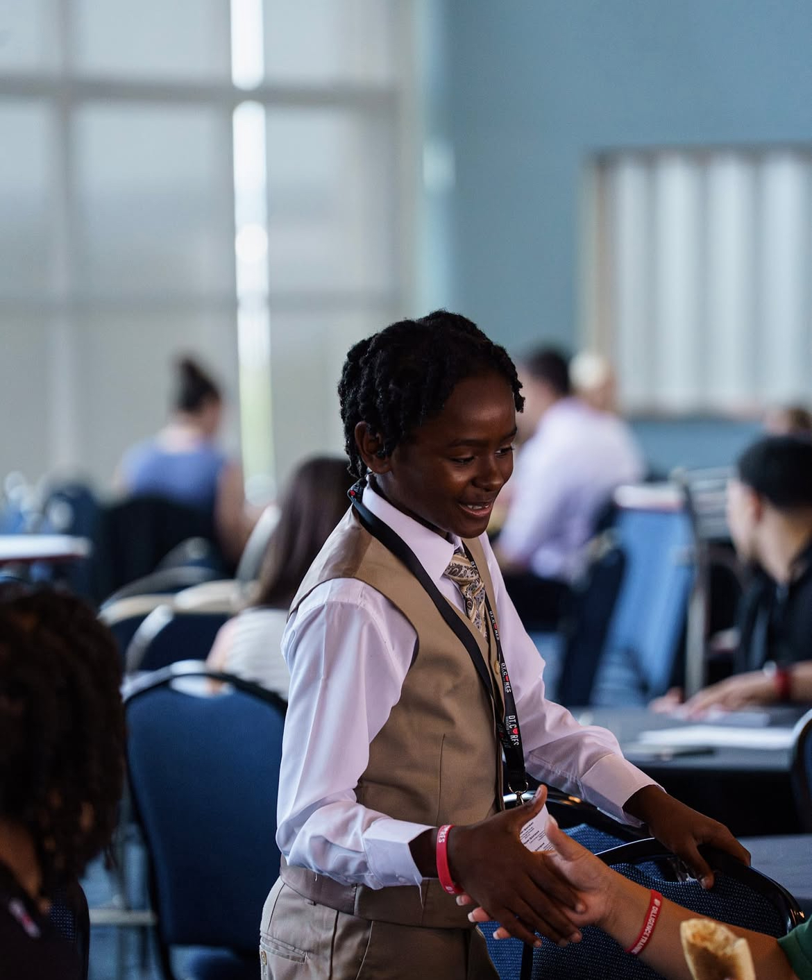 Young scholar in formal attire at the summit